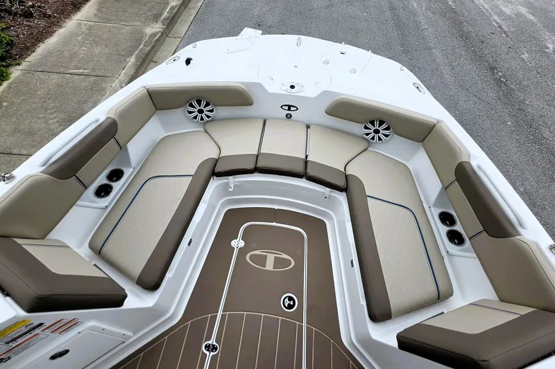Slide: The Image of 2027 Tahoe 2150 CC boat interior with beige seating and brown flooring. - 15