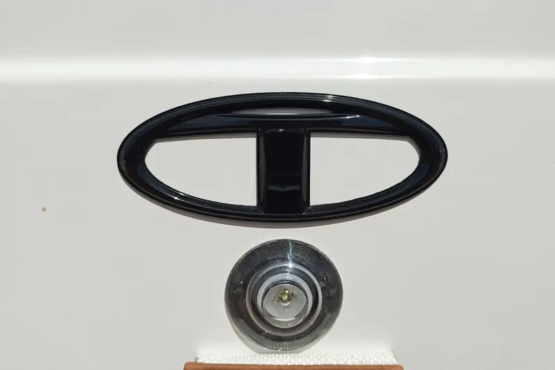 Slide: The Image of Close-up of a 2027 Tahoe 1950 logo and keyhole on a white surface. - 136