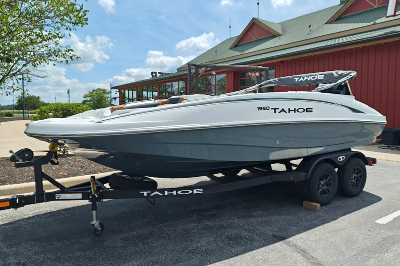 Slide: The Image of 2027 Tahoe 1950 boat on trailer, parked outdoors near a building. - 109