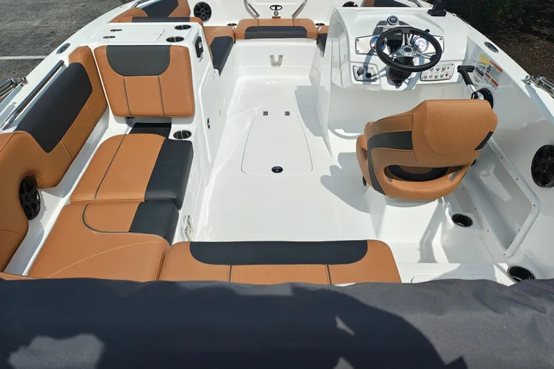 Slide: The Image of 2027 Tahoe 1950 boat interior with tan and black seating, modern steering console. - 117
