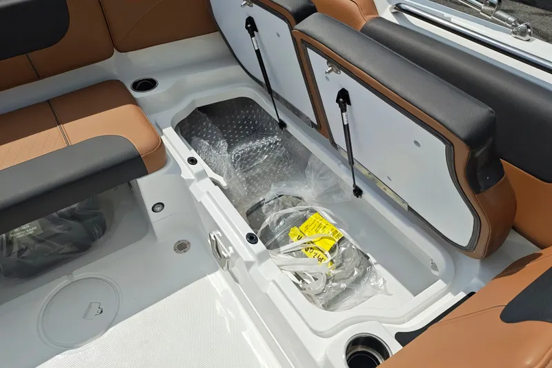 Slide: The Image of Interior storage compartment of 2027 Tahoe 1950 boat with brown and black seating. - 145