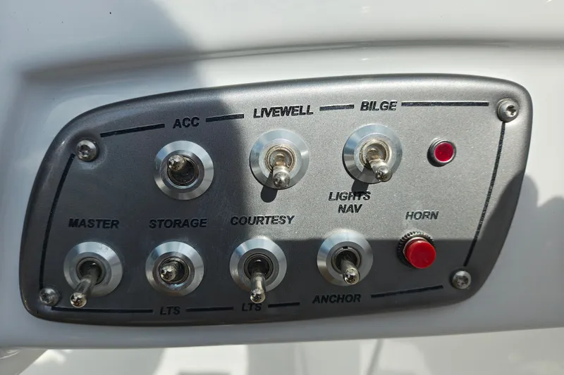 Slide: The Image of Control panel of a 2027 Tahoe 1950 boat with switches and labels. - 124
