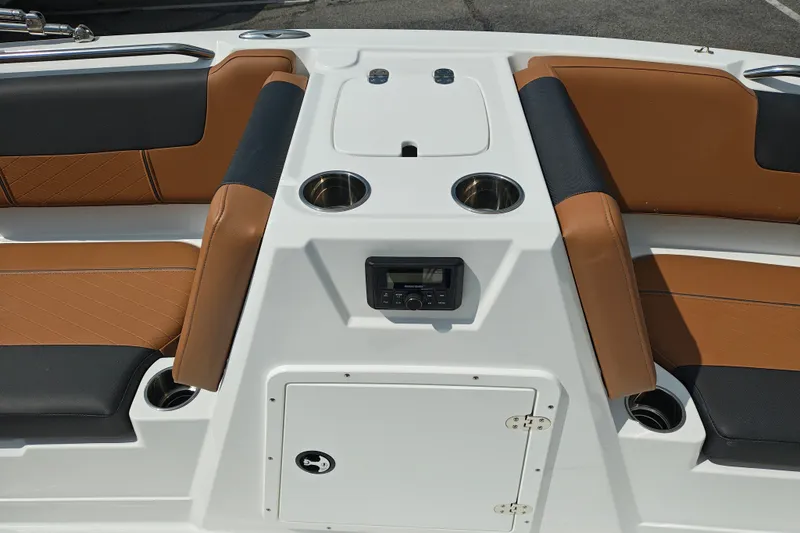 Slide: The Image of Interior of 2027 Tahoe 1950 boat with brown and black seating, cup holders, and control panel. - 128