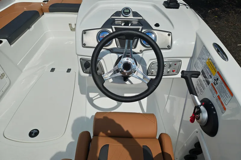 Slide: The Image of Steering console of a 2027 Tahoe 1950 boat with modern controls and tan seating. - 121