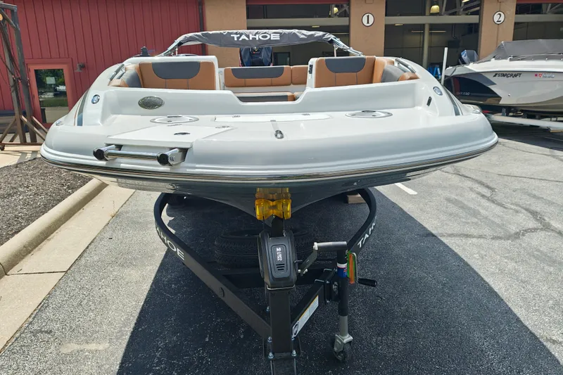 Slide: The Image of 2027 Tahoe 1950 boat on trailer, parked outdoors, showcasing sleek design and modern features. - 111