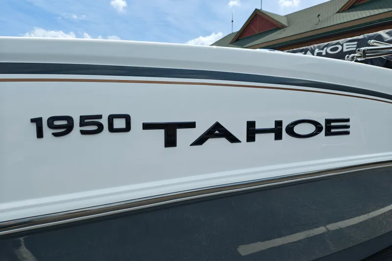Slide: The Image of 2027 Tahoe 1950 boat model, sleek design with bold lettering, under a clear blue sky. - 110