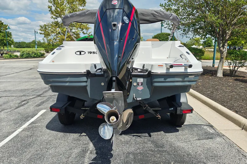 Slide: The Image of Rear view of a 2027 Tahoe 1950 boat on a trailer in a parking lot. - 115