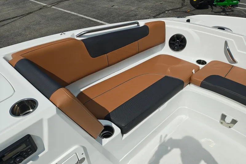 Slide: The Image of Luxurious seating in a 2027 Tahoe 1950 boat with brown and black upholstery. - 134