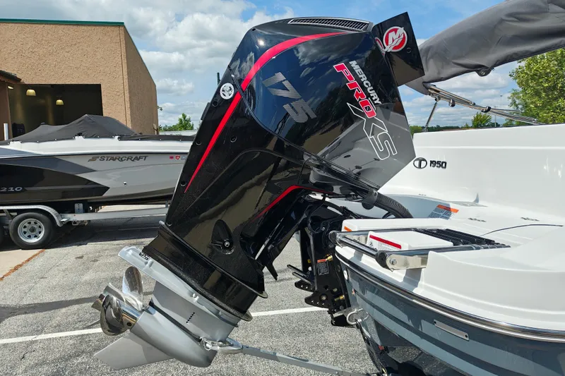 Slide: The Image of Outboard motor on a 2027 Tahoe 1950 boat, parked outdoors. - 114