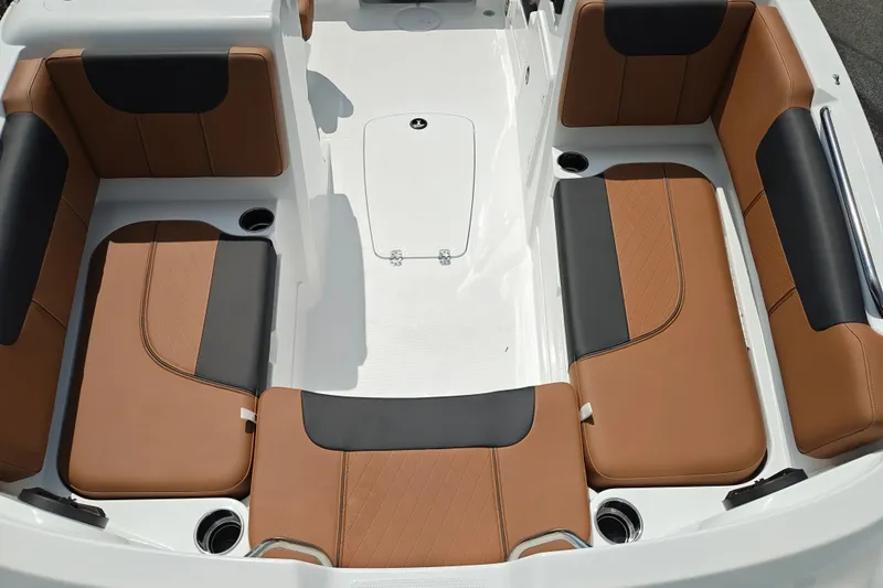 Slide: The Image of Interior seating of 2027 Tahoe 1950 boat with brown and black upholstery. - 140