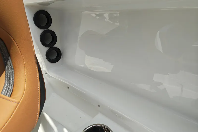 Slide: The Image of Interior detail of a 2027 Tahoe 1950 boat, featuring tan seating and cup holders. - 148