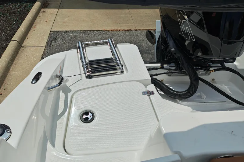 Slide: The Image of Rear view of 2027 Tahoe 1950 boat with ladder and engine details. - 150