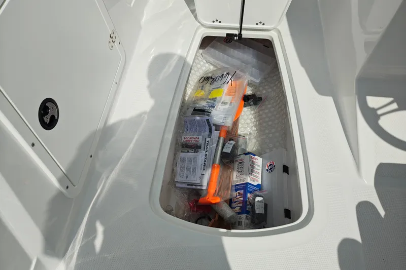 Slide: The Image of Storage compartment of a 2027 Tahoe 1950 boat filled with various boating supplies. - 131