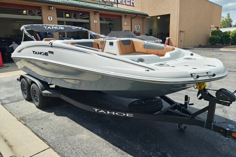 Slide: The Image of 2027 Tahoe 1950 boat on trailer outside dealership, showcasing sleek design and modern features. - 112
