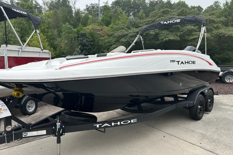 The Image of 2027 Tahoe 2150 boat on trailer, sleek design, parked outdoors. - 0