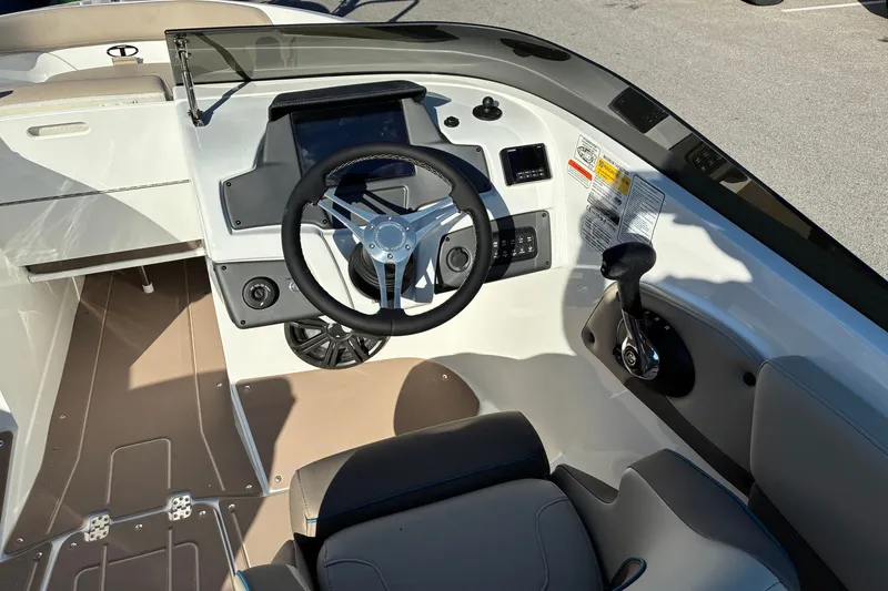 Slide: The Image of 2027 Tahoe 210 S boat cockpit with steering wheel and control panel. - 10