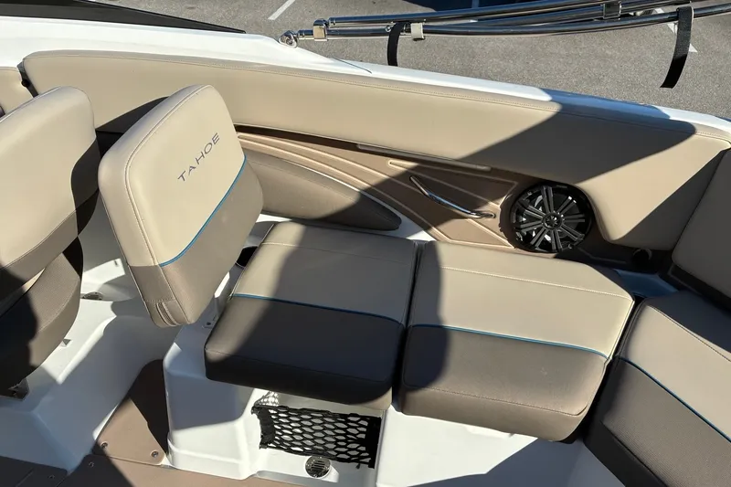 Slide: The Image of Interior seating of 2027 Tahoe 210 S boat with beige upholstery and speaker. - 15