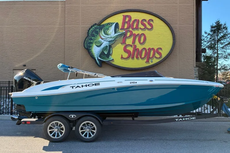 Slide: The Image of 2027 Tahoe 210 S boat displayed outside Bass Pro Shops store. - 1
