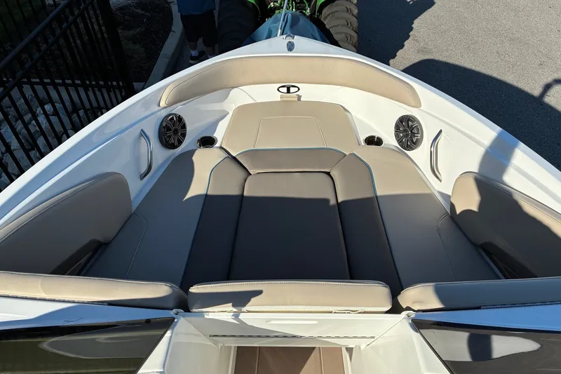 Slide: The Image of 2027 Tahoe 210 S boat interior with beige seating and built-in speakers. - 9
