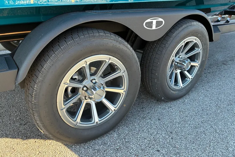 Slide: The Image of Close-up of 2027 Tahoe 210 S trailer wheels on asphalt surface. - 5