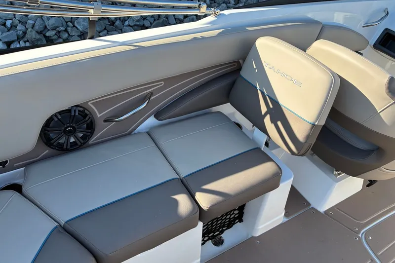 Slide: The Image of 2027 Tahoe 210 S boat interior with cushioned seating and built-in speaker. - 14