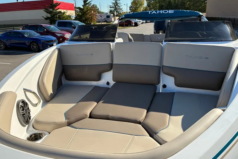 Slide: The Image of 2027 Tahoe 210 S boat interior with beige seating and cup holders. - 8