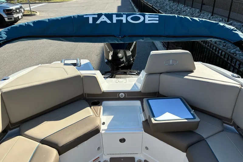 Slide: The Image of 2027 Tahoe 210 S boat interior with seating and storage, featuring a blue canopy. - 13