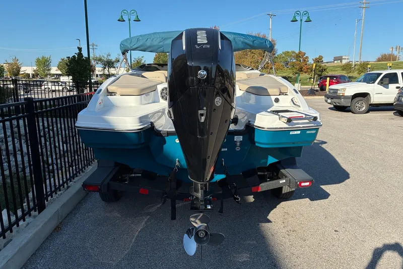 Slide: The Image of 2027 Tahoe 210 S boat with outboard motor in a parking lot. - 3