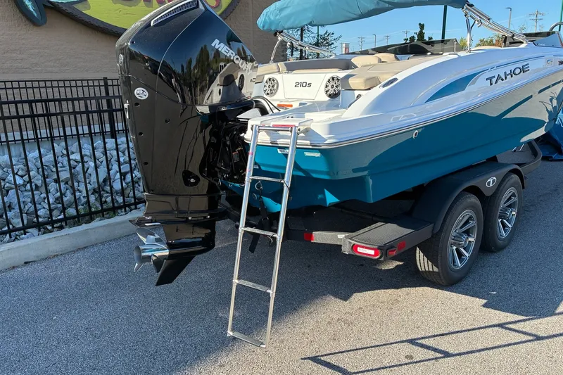 Slide: The Image of 2027 Tahoe 210 S boat with Mercury engine on trailer, featuring a rear ladder. - 4