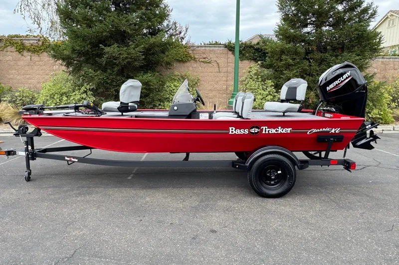 The Image of 2027 Tracker Bass Tracker Classic XL boat, red, parked on trailer, side view. - 0