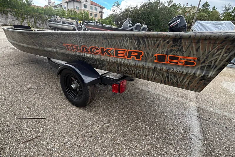 The Image of 2027 Tracker Grizzly 15 Jon boat with camouflage design on a trailer. - 0