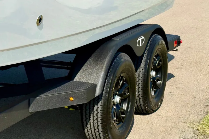 Slide: The Image of 2027 Tahoe 2150 trailer with dual black wheels on a sunny day. - 20