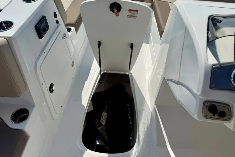 Slide: The Image of 2027 Tahoe 2150 boat interior storage compartment with open hatch and visible equipment. - 15