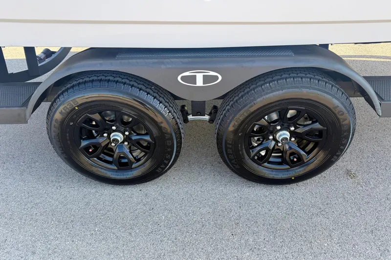 Slide: The Image of 2027 Tahoe 2150 trailer with dual black alloy wheels on pavement. - 21