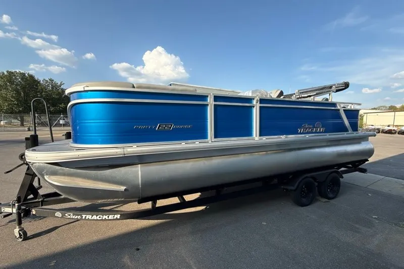 The Image of 2027 Sun Tracker Party Barge 22 RF DLX pontoon boat on trailer, blue exterior. - 0