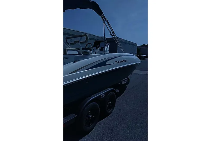 The Image of 2027 Tahoe 2150 CC boat on trailer, parked outdoors under clear sky. - 0
