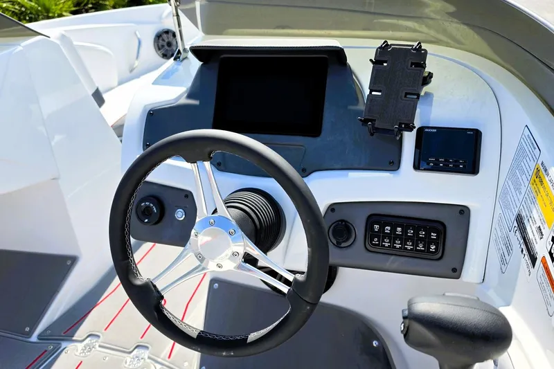 Slide: The Image of Steering console of 2027 Tahoe 210 S boat with modern controls and display. - 14