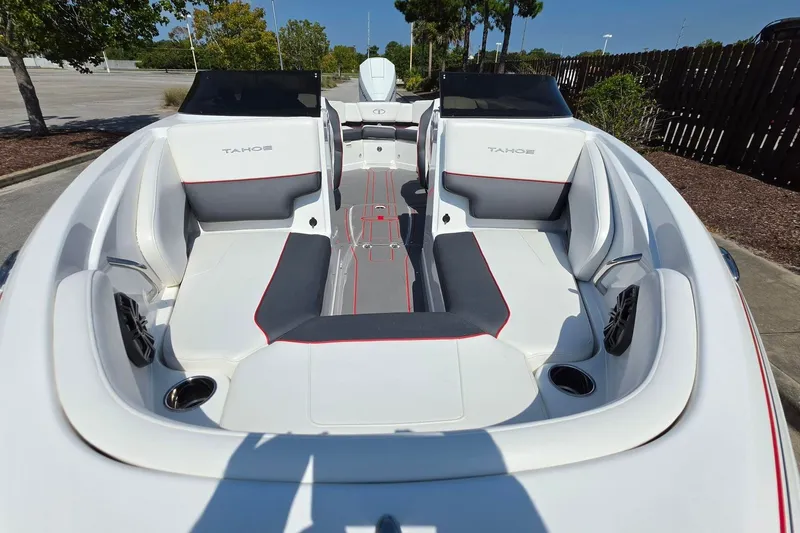 Slide: The Image of 2027 Tahoe 210 S boat interior with white and gray seating, red accents, and cup holders. - 16