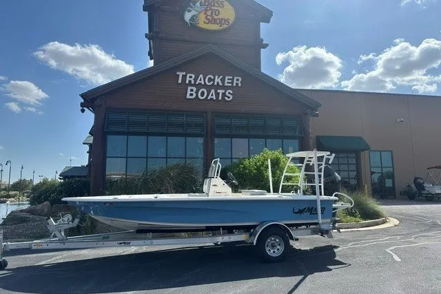 The Image of 2026 Mako 18 Pro Skiff boat on trailer outside Tracker Boats store. - 0
