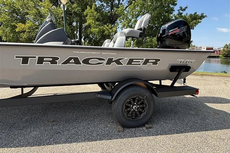 Slide: The Image of 2027 Tracker Pro Team 195 boat on trailer, parked near a lake. - 23