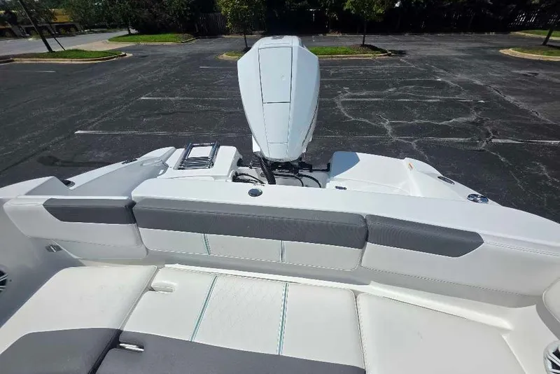 Slide: The Image of 2027 Tahoe 2150 CC boat with sleek seating and modern outboard motor design. - 13
