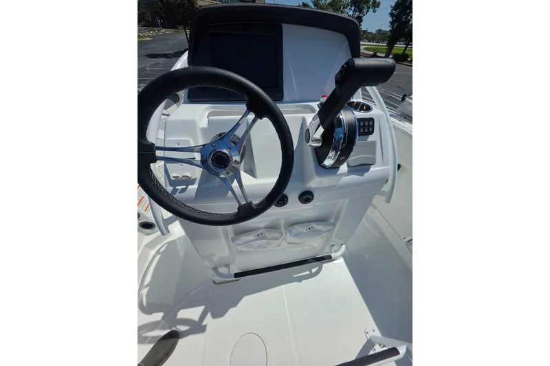 Slide: The Image of 2027 Tahoe 2150 CC boat console with steering wheel and controls. - 11