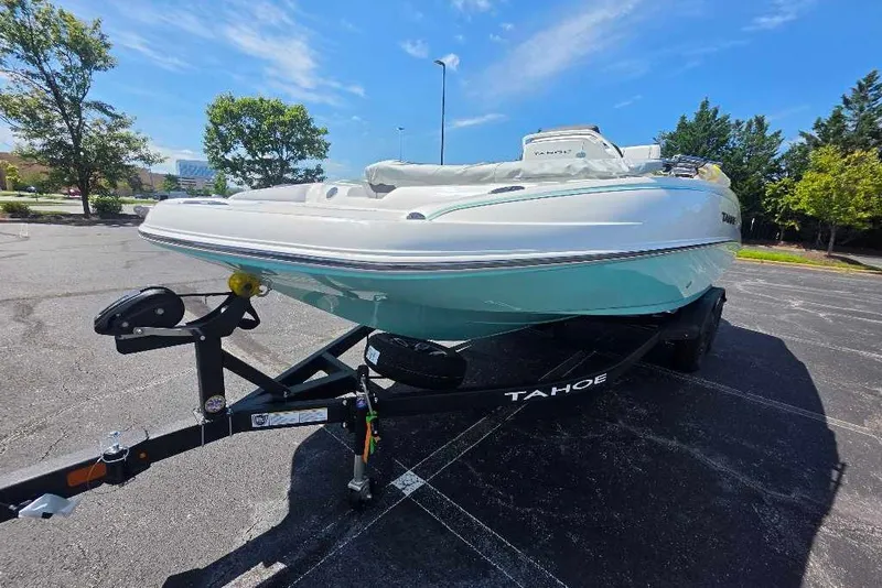 Slide: The Image of 2027 Tahoe 2150 CC boat on trailer in sunny parking lot. - 1