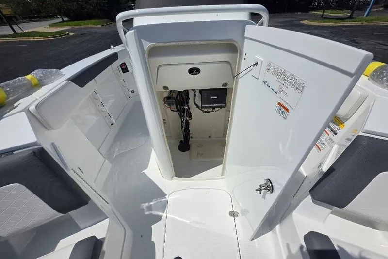 Slide: The Image of 2027 Tahoe 2150 CC boat interior with open storage compartment and visible wiring. - 8