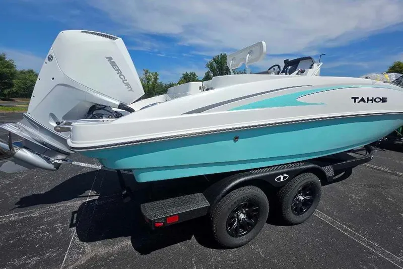 Slide: The Image of 2027 Tahoe 2150 CC boat with Mercury engine on trailer, parked outdoors. - 5
