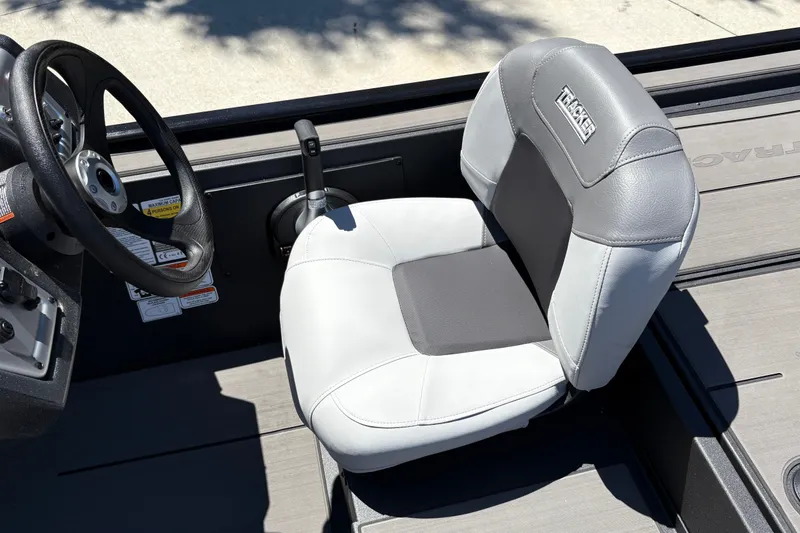 Slide: The Image of 2027 Tracker Pro 170 boat interior with steering wheel and cushioned seat. - 27