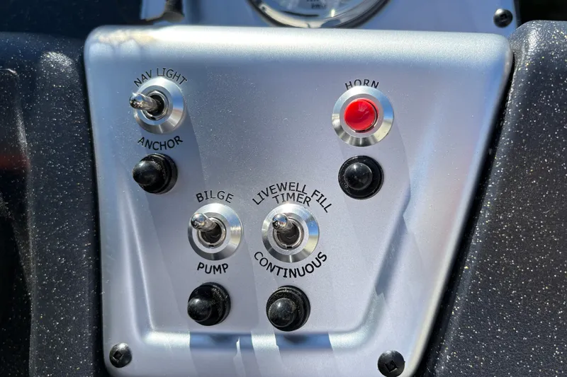 Slide: The Image of Control panel of 2027 Tracker Pro 170 boat with switches and buttons. - 18