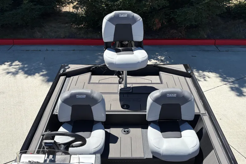 Slide: The Image of 2027 Tracker Pro 170 boat interior with three cushioned seats on deck. - 16