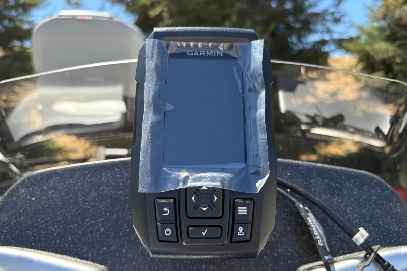 Slide: The Image of Garmin device on 2027 Tracker Pro 170 dashboard, outdoors with trees in background. - 26