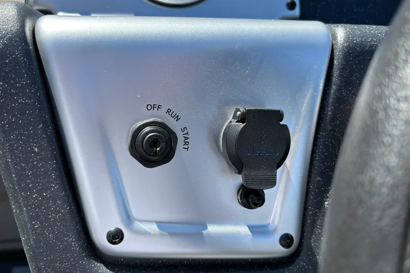 Slide: The Image of Control panel of 2027 Tracker Pro 170 boat with ignition switch and AquaAmp port. - 19